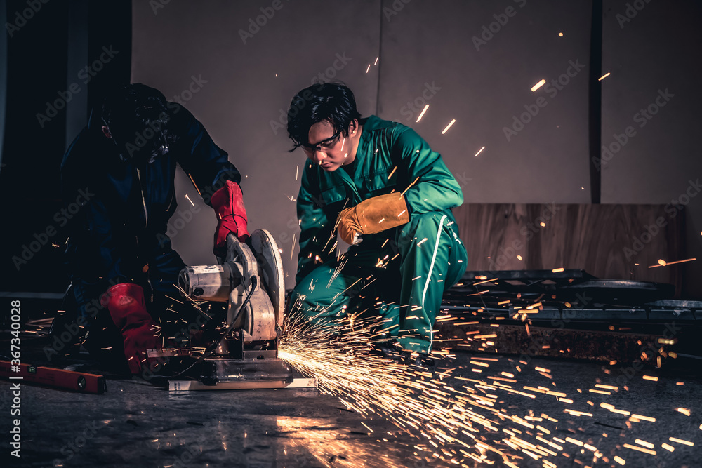 Professional mechanic man is cutting steel metal with rotating carbon blade cutter. Steel industry a