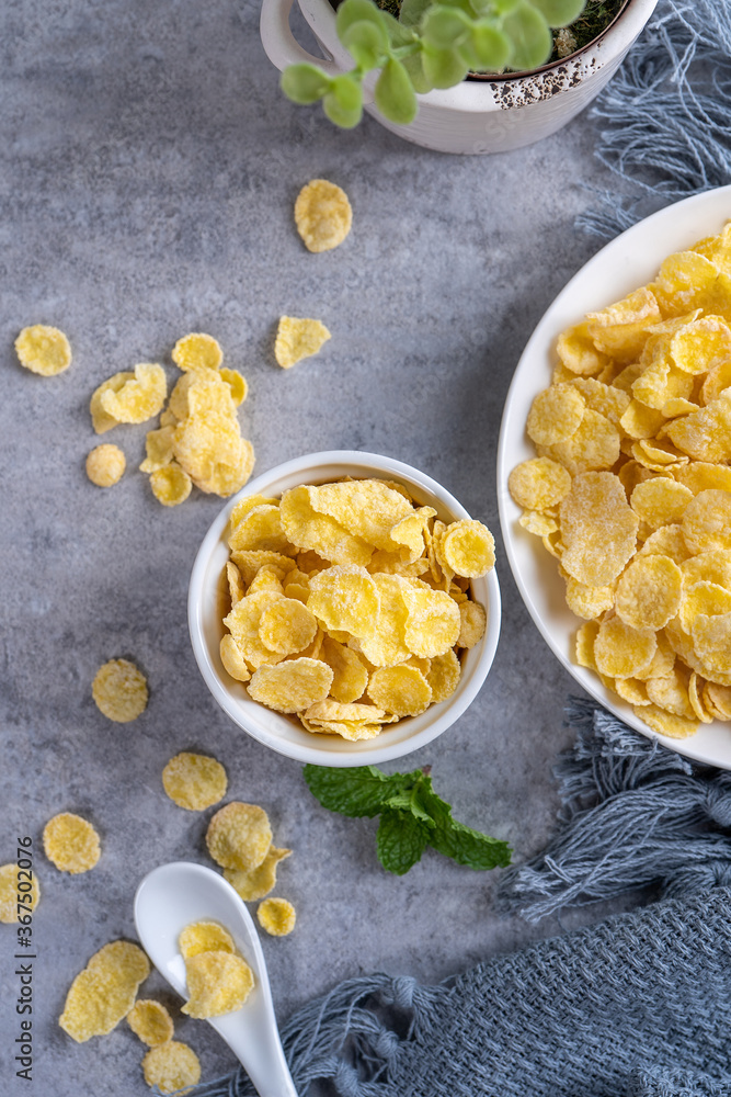 Corn flakes bowl sweets on gray cement background, top view flat lay layout design, fresh and health