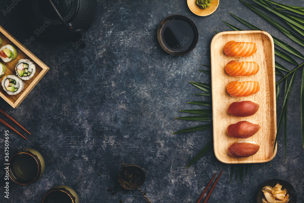 Nigiri sushi set with salmon and tuna served on bamboo plate