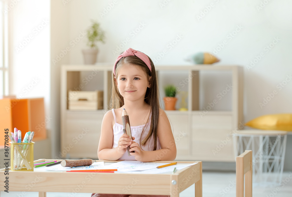 Cute little girl coloring pictures at home