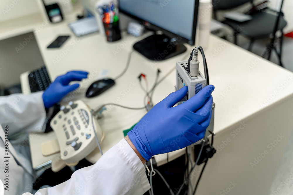 Electromyography in doctor`s hands. Medical examination. EMG. Selective focus.