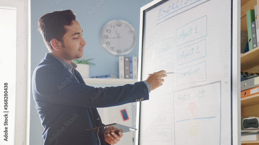 School Class: Portrait of the Enthusiastic and Motivated Teacher Using Digital Whiteboard and Tablet