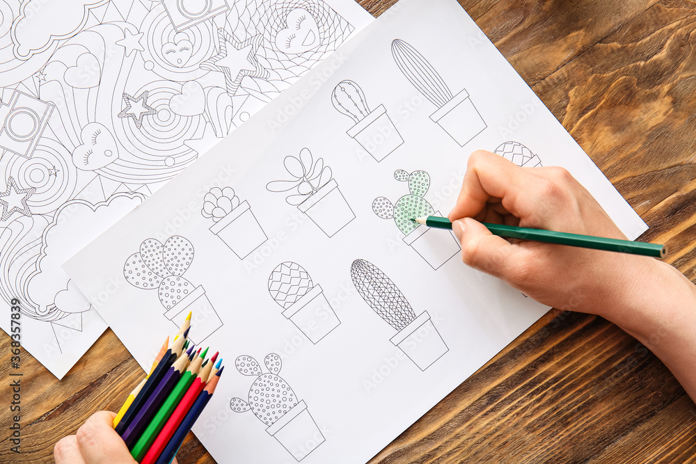 Woman coloring picture at table