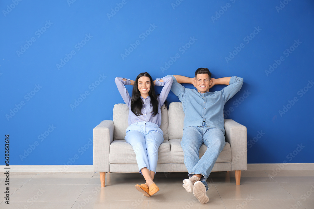 Young couple relaxing on sofa at home