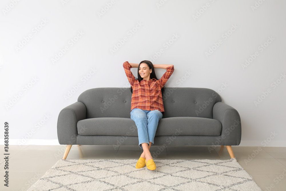 Young woman relaxing on sofa at home