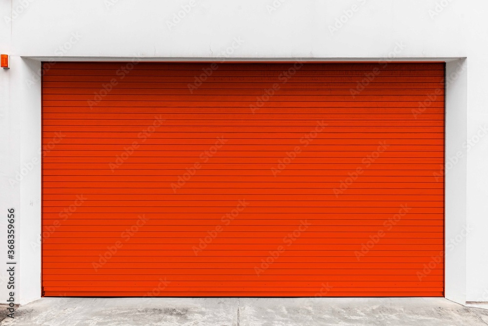 Automatic red roller shutter doors on the ground floor of the house