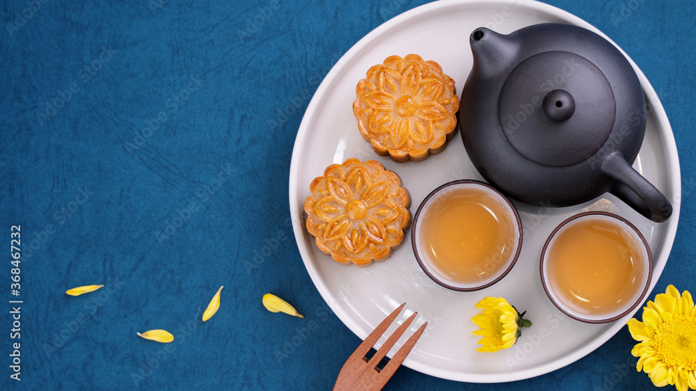 Minimal simplicity layout moon cakes on blue background for Mid-Autumn Festival, creative food desig