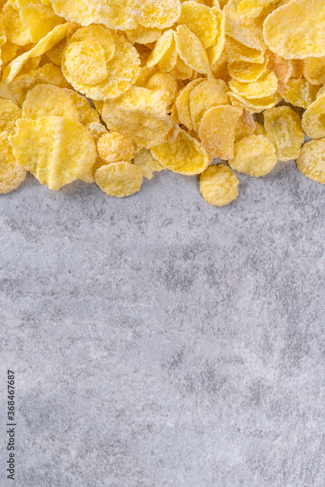 Corn flakes bowl sweets on gray cement background, top view flat lay layout design, fresh and health