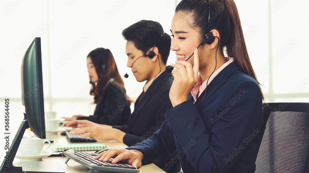 Business people wearing headset working in office to support remote customer or colleague. Call cent