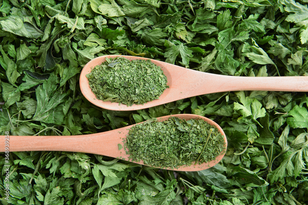 Spoons with heap of fresh parsley