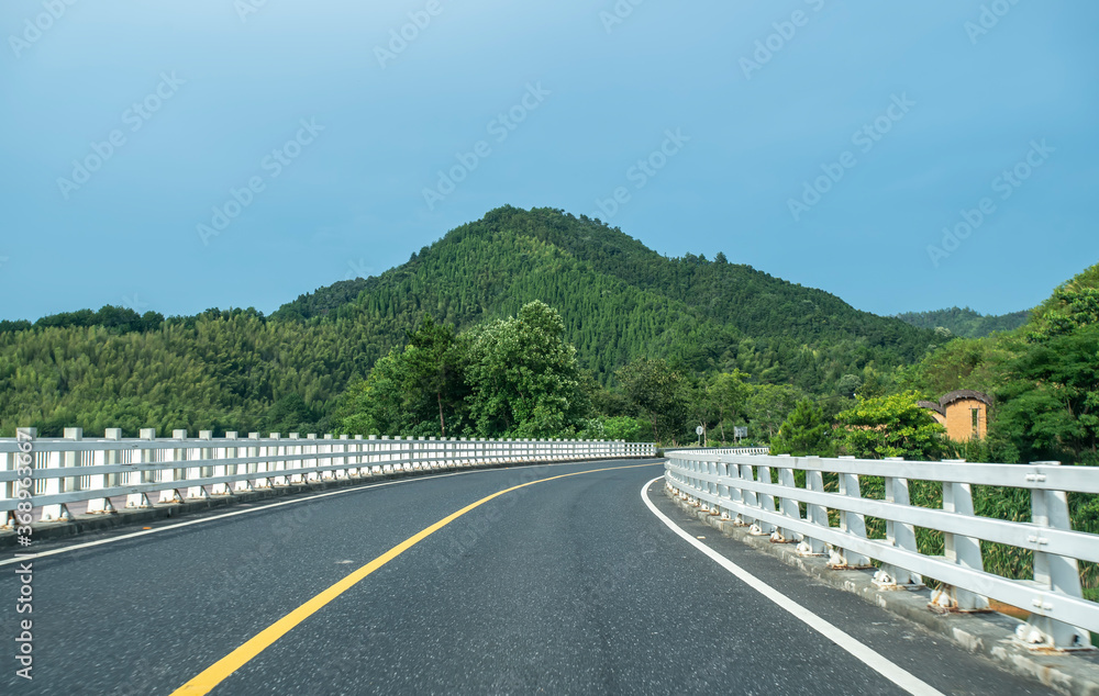 Highway and green mountain background