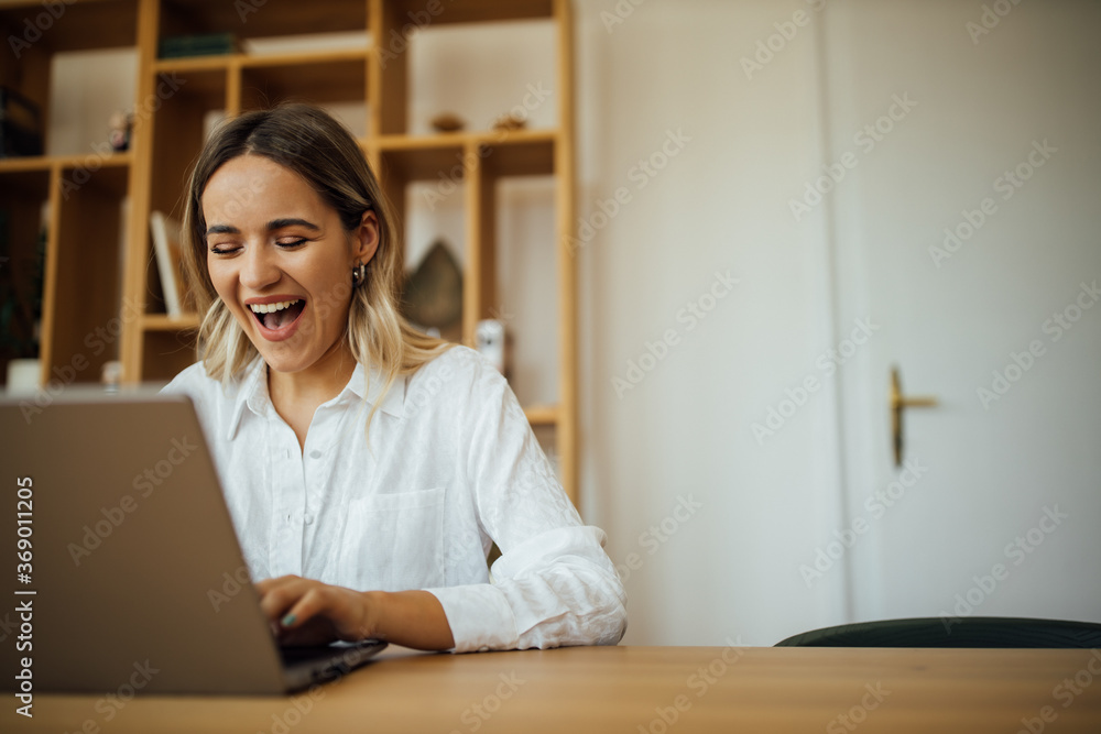 Smiling women using laptop.