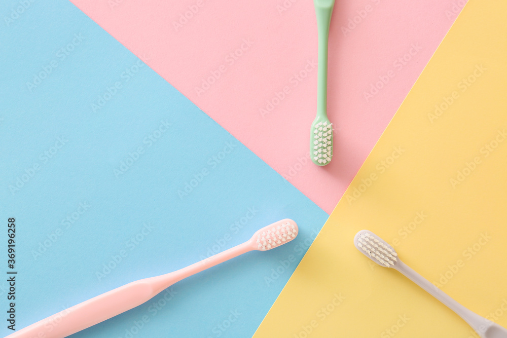 Tooth brushes on color background