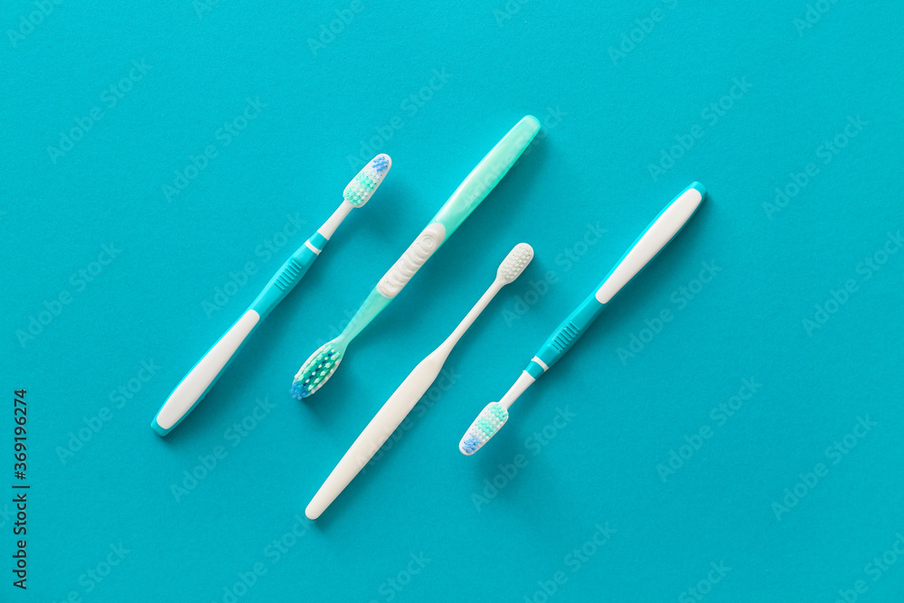 Tooth brushes on color background