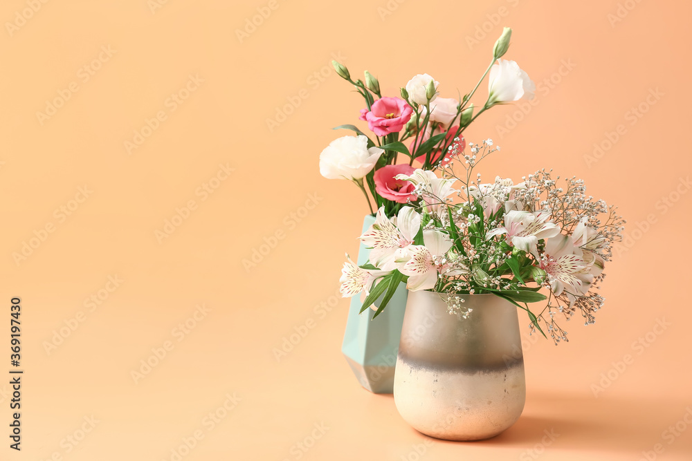 Beautiful vases with flowers on color background