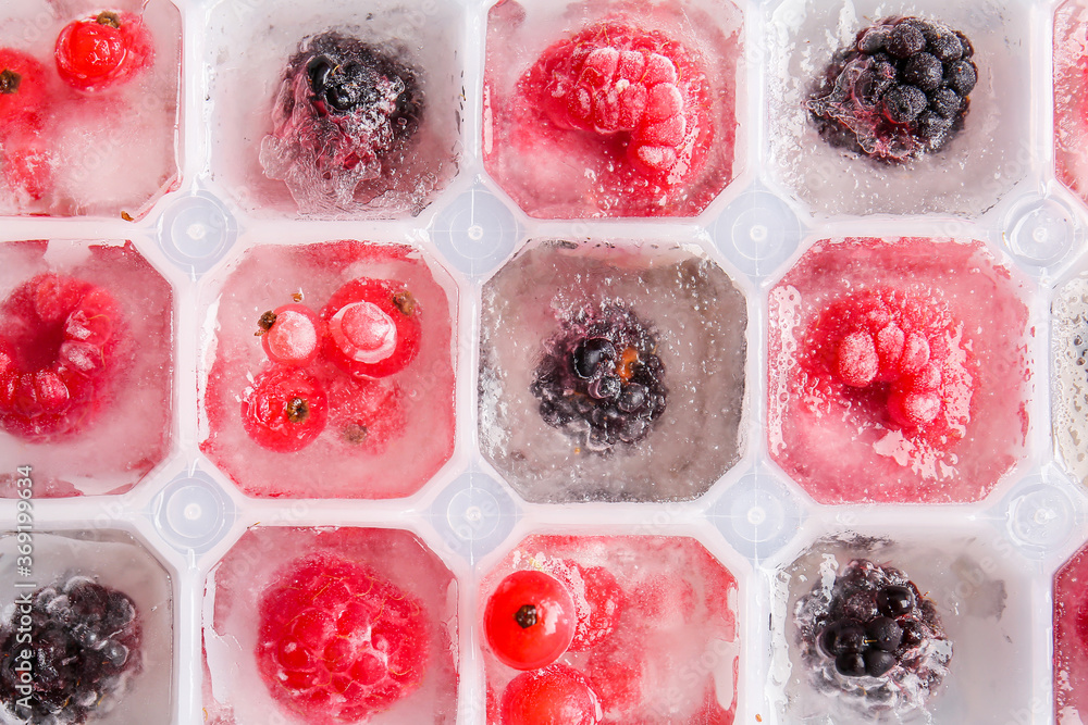 Tray with berries in ice, closeup