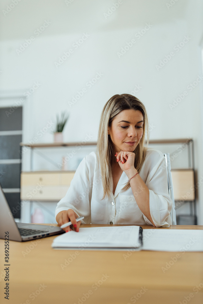 Portrait of a pensive businesswoman reading.