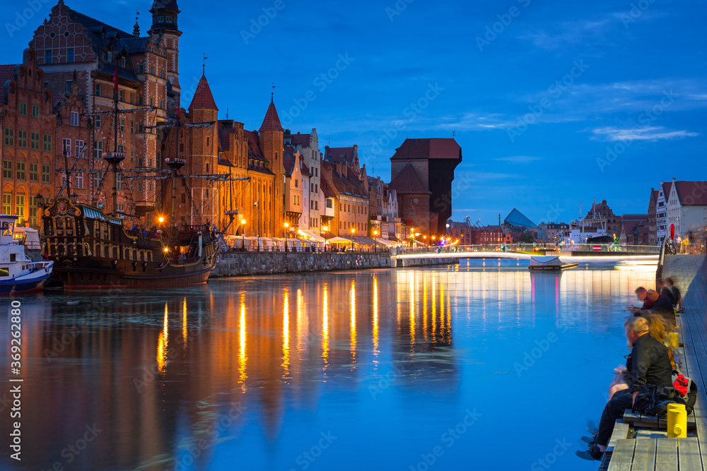 Amazing architecture of Gdansk old town at night with a new footbridge over the Motlawa River. Polan