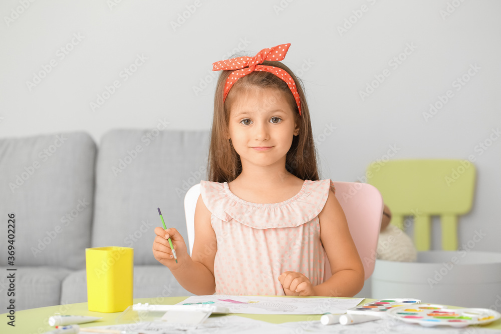 Cute little girl coloring pictures at home