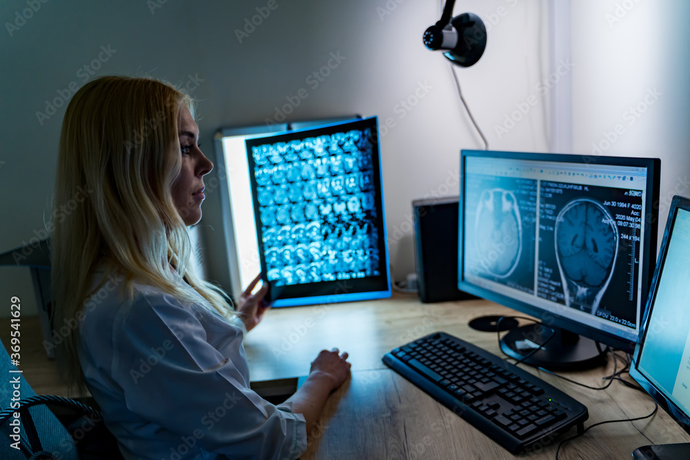 Hospital doctor holding patients x-ray film. Modern office background. Healthcare, roentgen, people