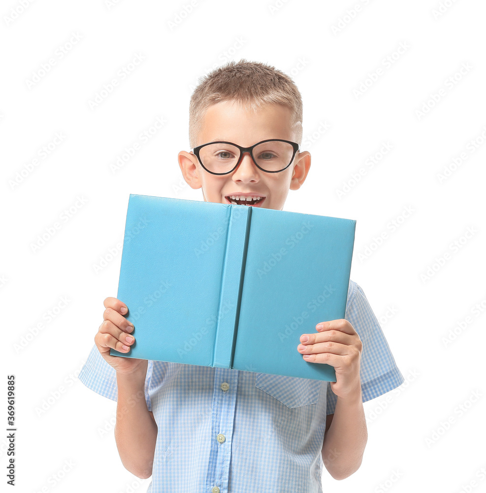 Cute little boy with book on white background