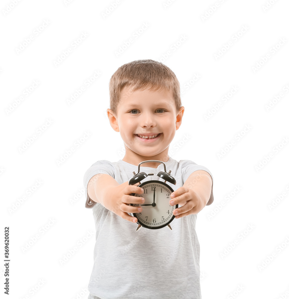 Little boy with alarm clock on white background