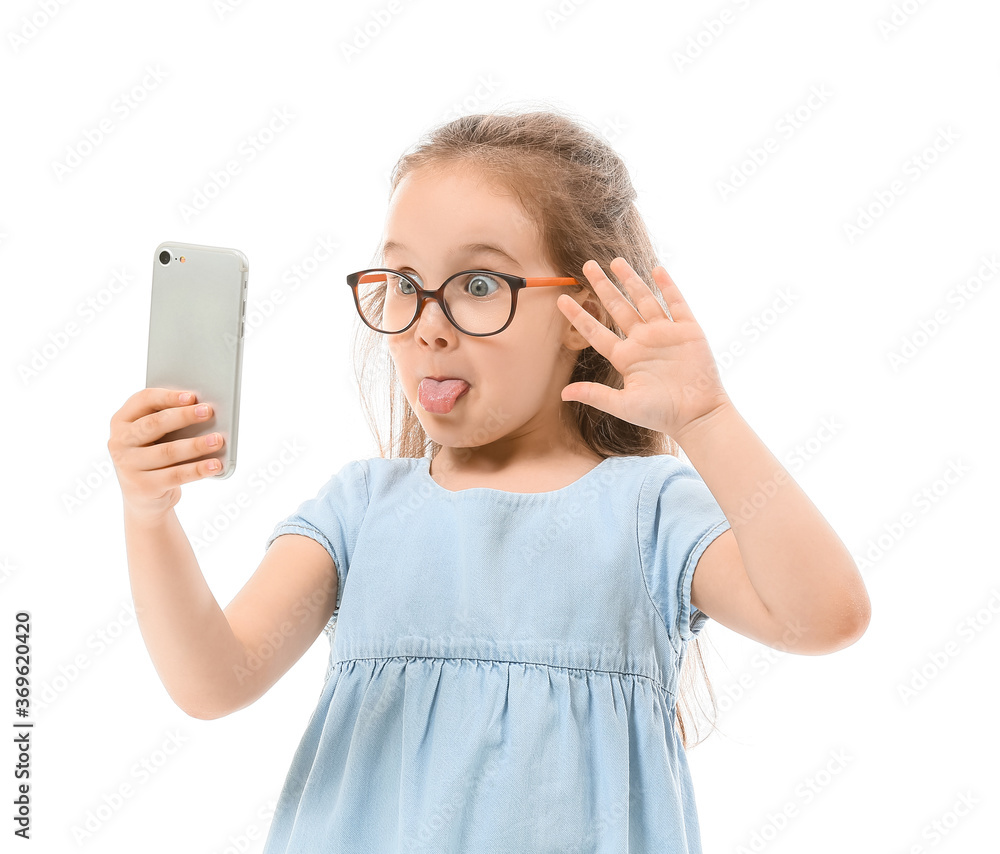 Cute little girl taking selfie on white background