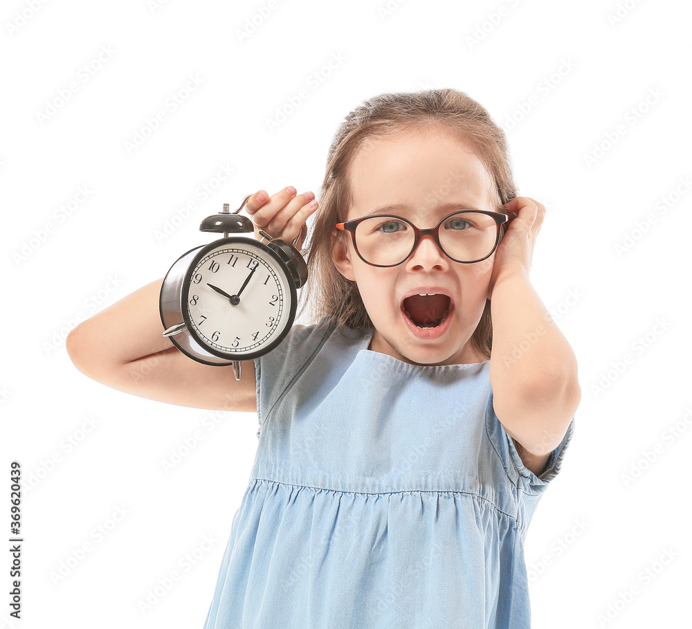 Stressed little girl with alarm clock on white background