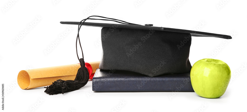 Graduation hat, diploma, apple and book on white background