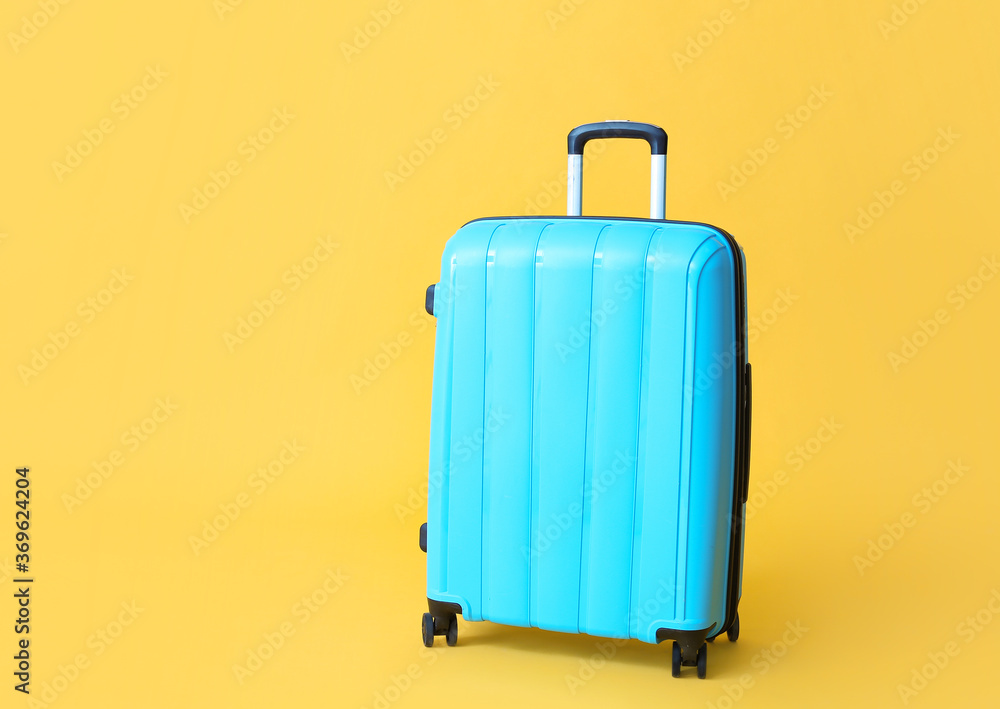 Packed suitcase on color background. Travel concept