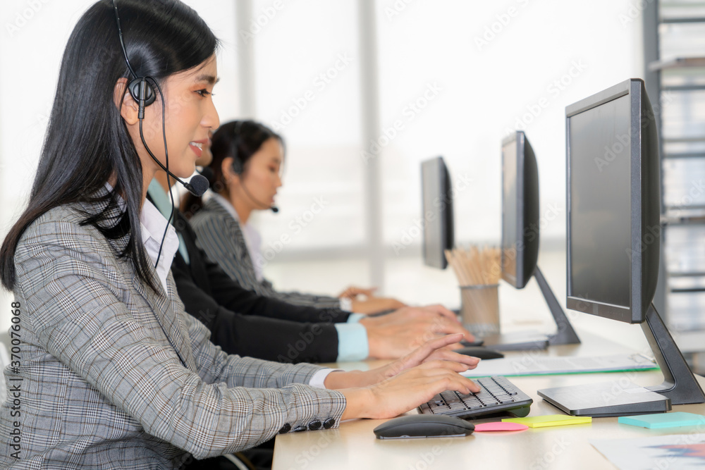 Business people wearing headset working in office to support remote customer or colleague. Call cent