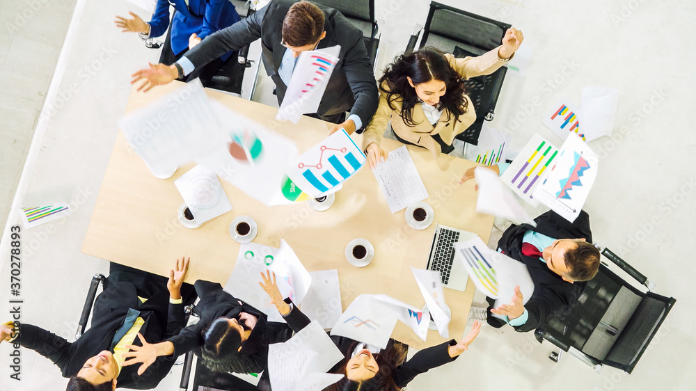 Successful business people celebrate together with joy at office table shot from top view . Young bu