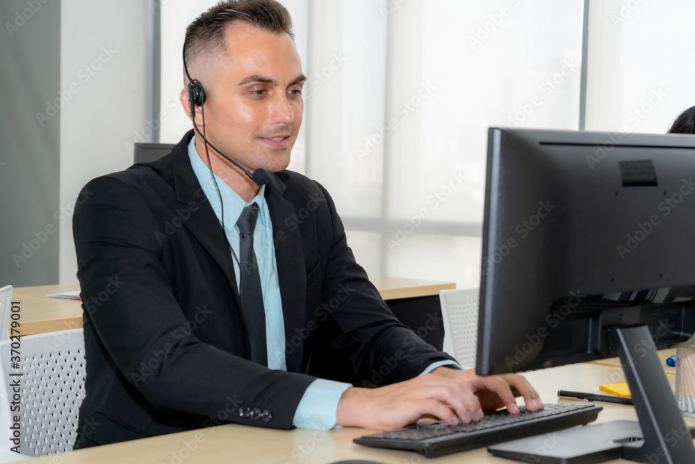 Business people wearing headset working in office to support remote customer or colleague. Call cent