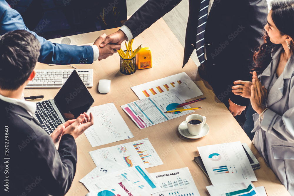 Group business people handshake at meeting table in office together with confident shot from top vie