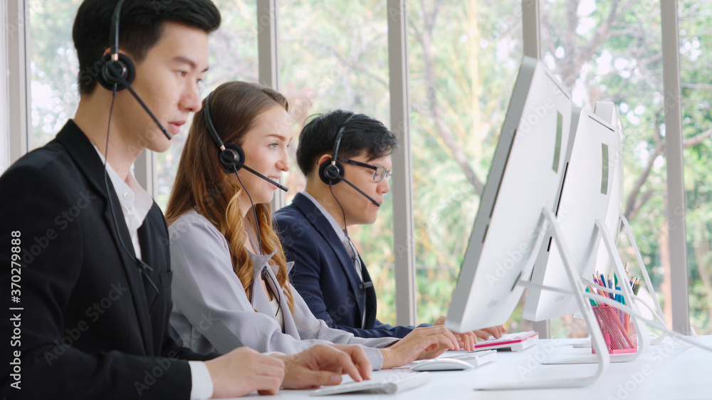 Business people wearing headset working in office to support remote customer or colleague. Call cent