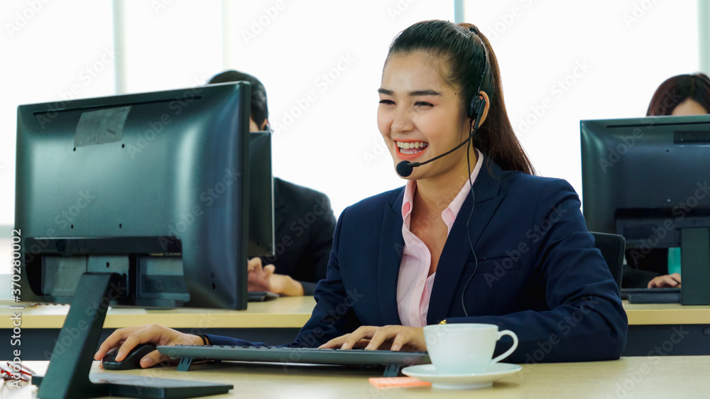 Business people wearing headset working in office to support remote customer or colleague. Call cent