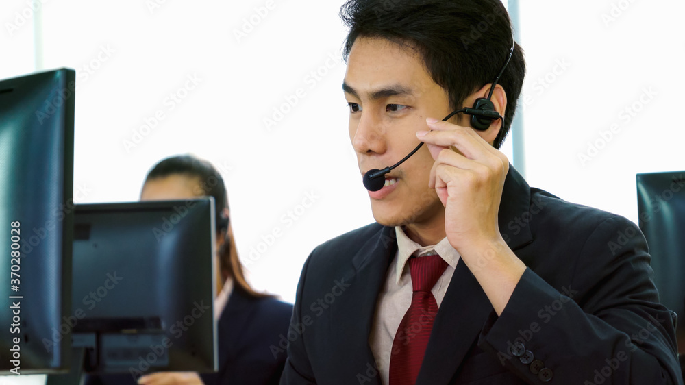 Business people wearing headset working in office to support remote customer or colleague. Call cent