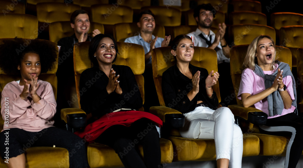 People audience watching movie in the movie theater cinema. Group recreation activity and entertainm