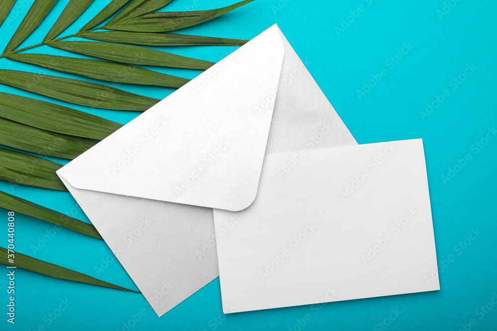 Blank card and envelope on color background