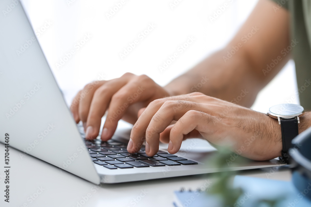 Young man using laptop for online learning at home