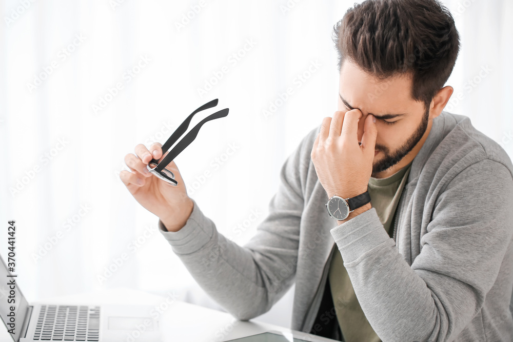 Tired young man learning at home