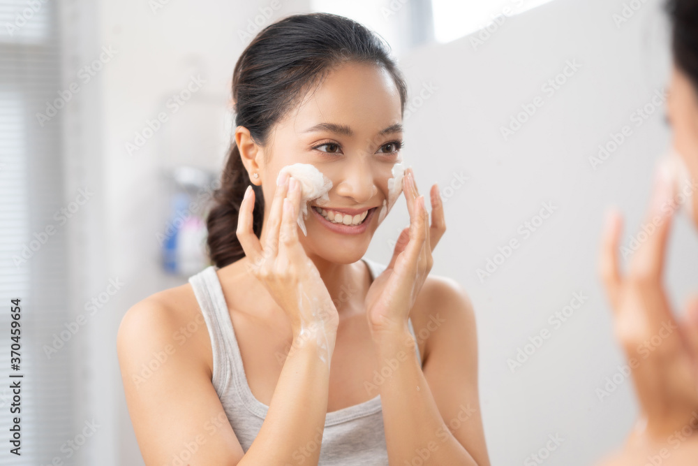 Beautiful female asian Wash face  in bathroom