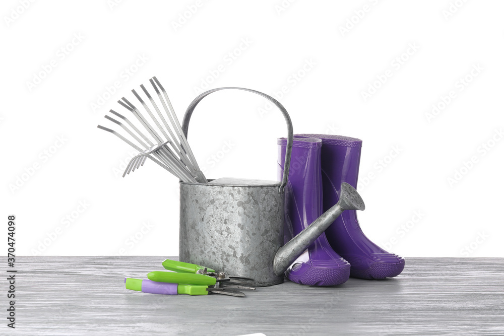 Gardening tools on table against white background