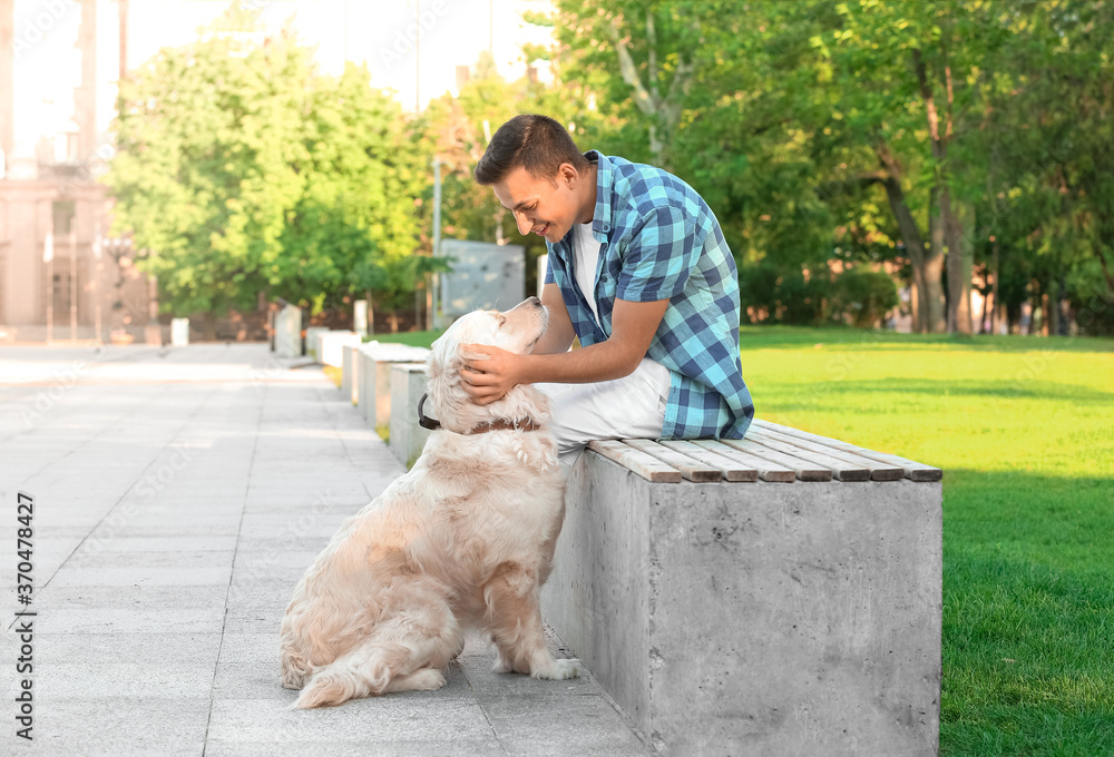 Young man with cute dog walking outdoors