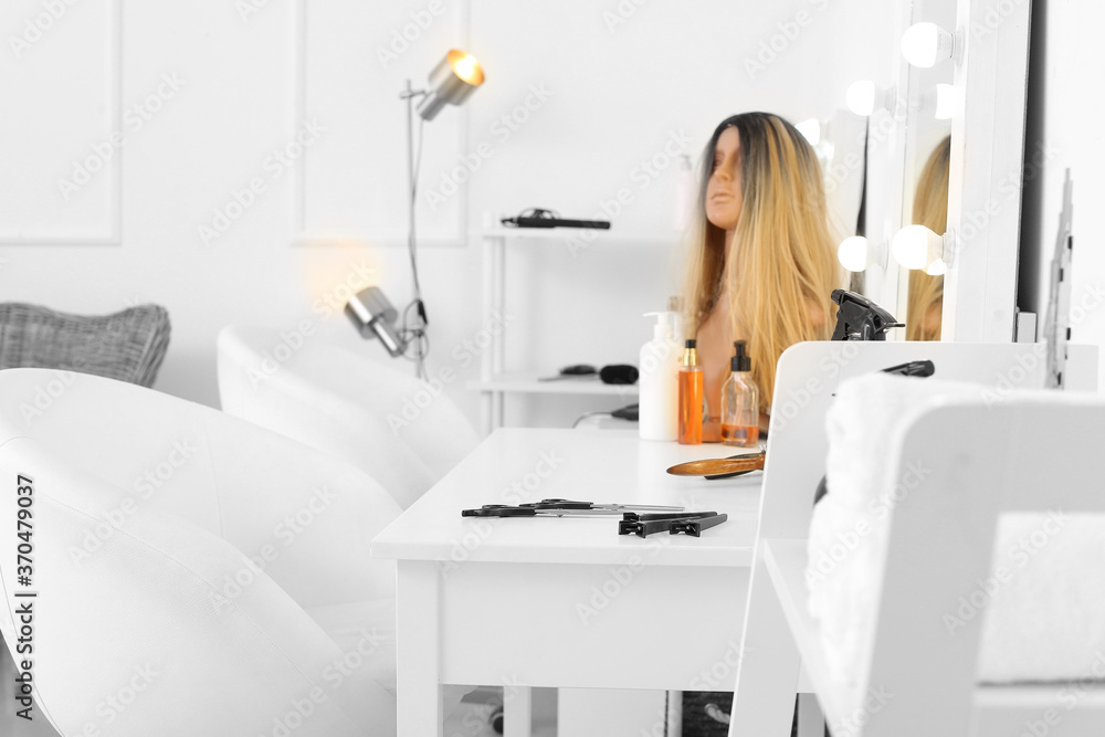 Table with mirror and supplies in hairdresser salon