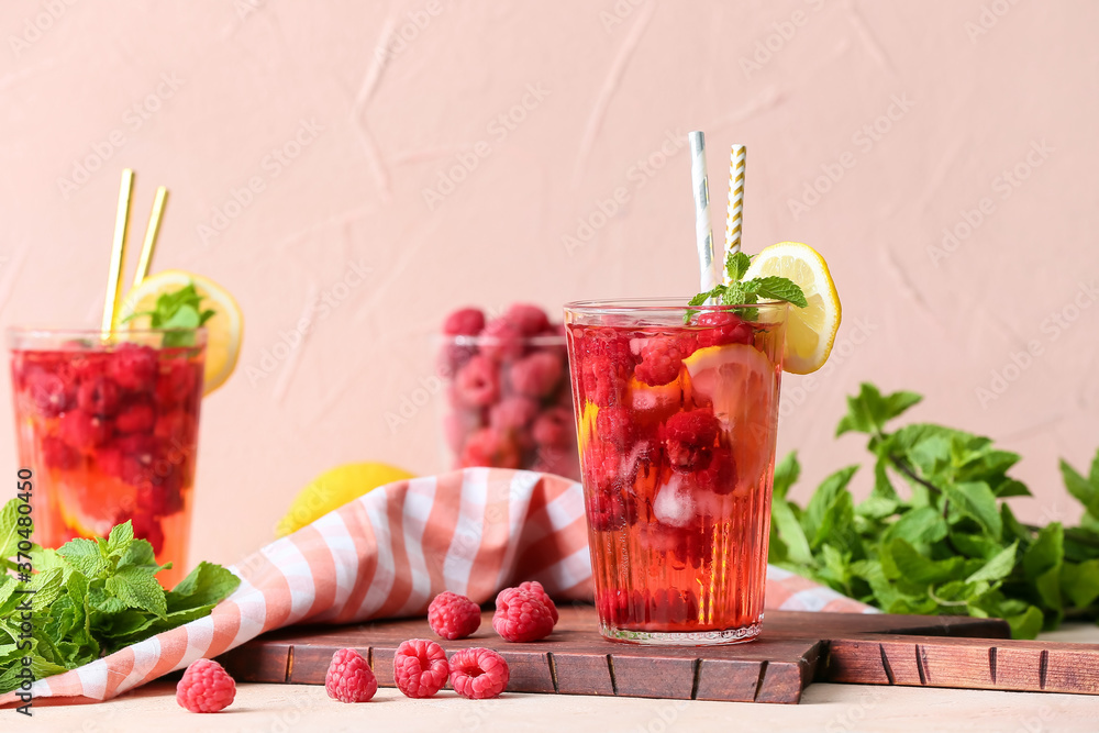 Glass of cold raspberry tea on table