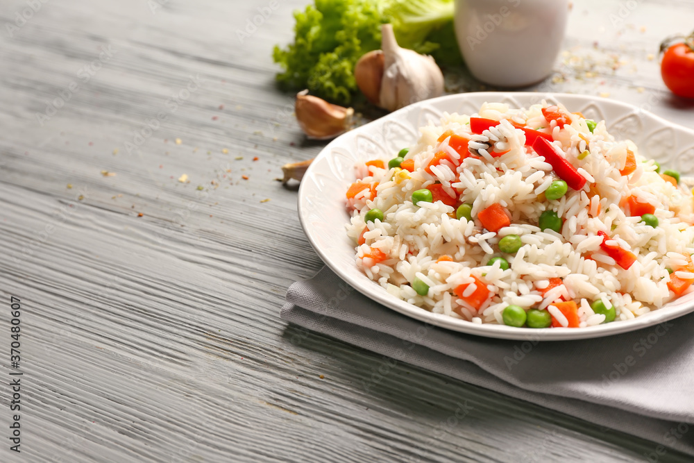 Plate with tasty pilaf on table