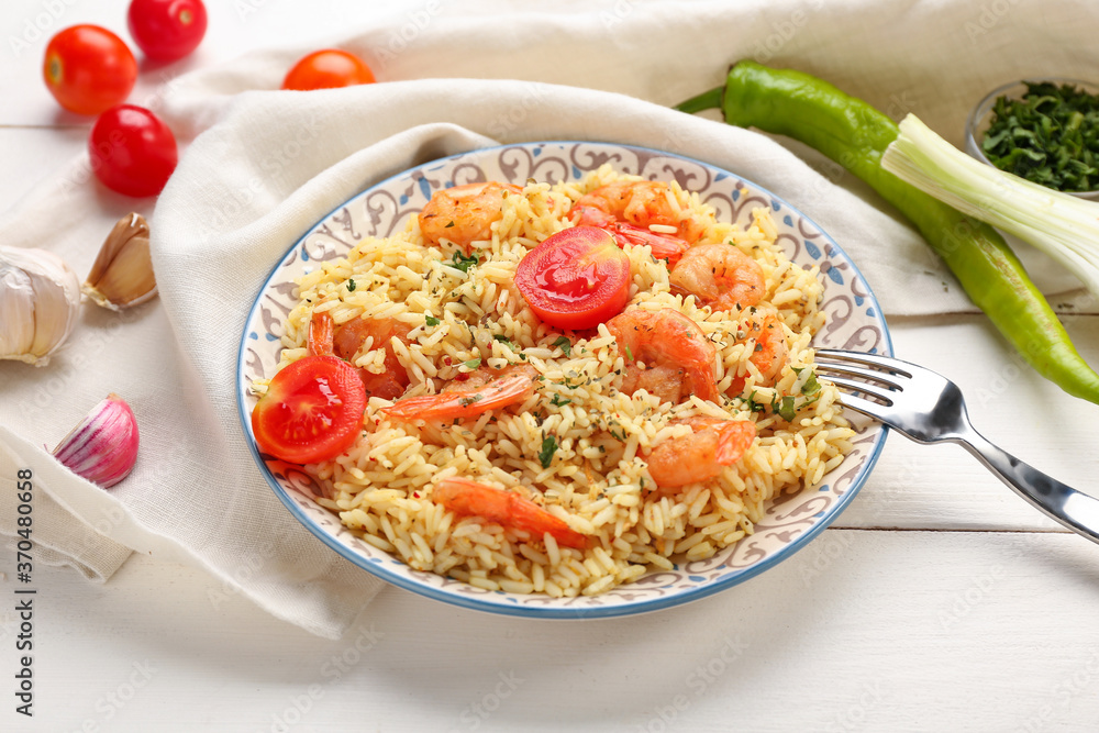 Plate with tasty pilaf on table