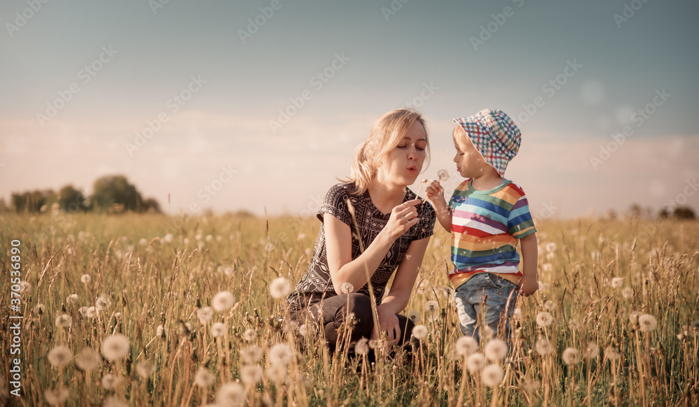 Young woman with a boy blowing bubbles