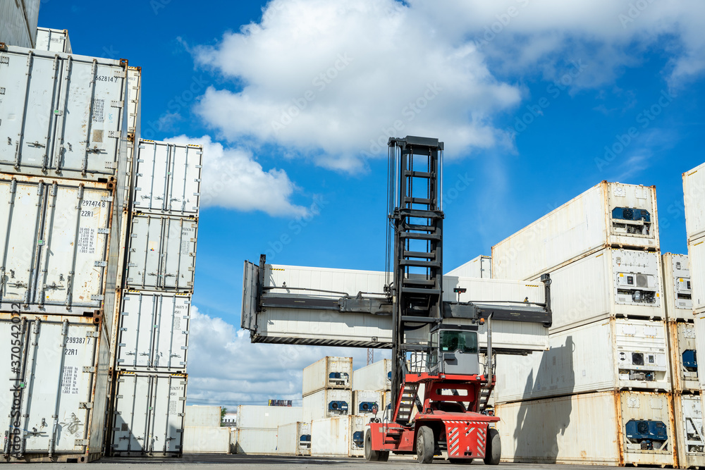 Forklift truck handling cargo shipping container box at container cargo.